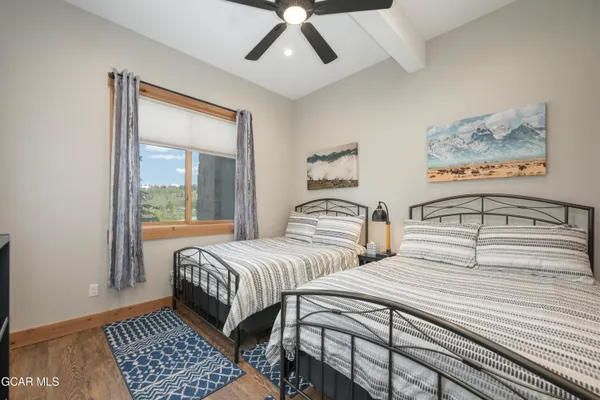 a bedroom with beds and a window
