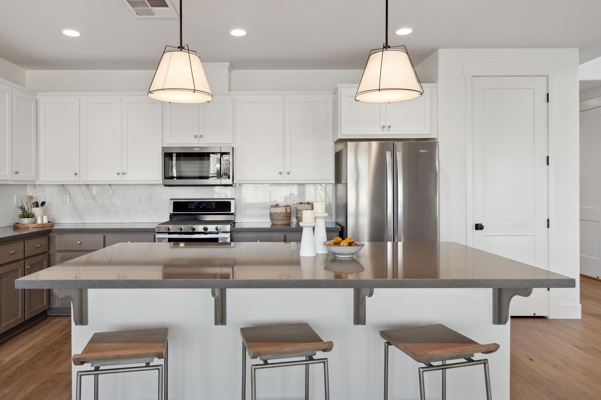 1516 Millennium Way Fairfield, CA 94533 - Photo 13 of 57 a kitchen with kitchen island granite countertop a sink cabinets and refrigerator
