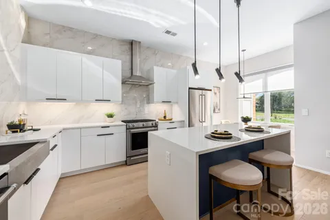 a kitchen with a stove a sink a window and cabinets