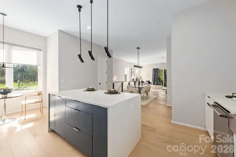 a kitchen with kitchen island a sink appliances and a counter top space