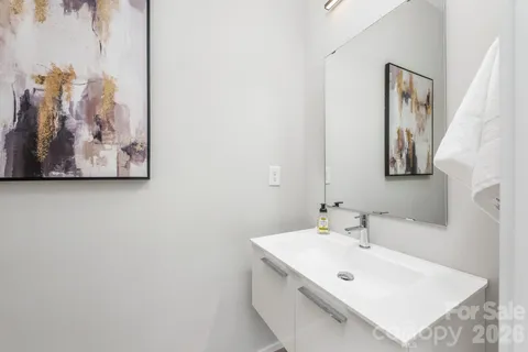 a bathroom with a sink mirror and vanity