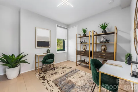 a view of a workspace with furniture and a potted plant