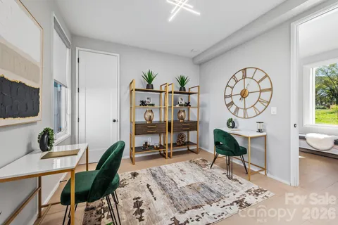 a living room with furniture a rug and a large window