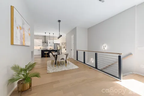 a living room with furniture a table and kitchen view