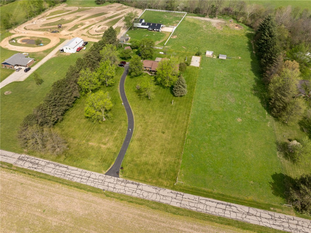 7988 McCool Road Greenville, OH 45331 - Photo 40 of 50 An aerial view showcases a verdant property with winding driveways and surrounding greenery.