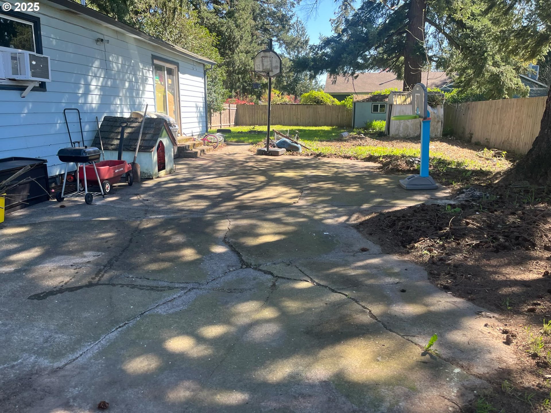 933 Southeast 174th Avenue Portland, OR 97233 - Photo 11 of 14 a view of a patio with table and chairs with wooden fence
