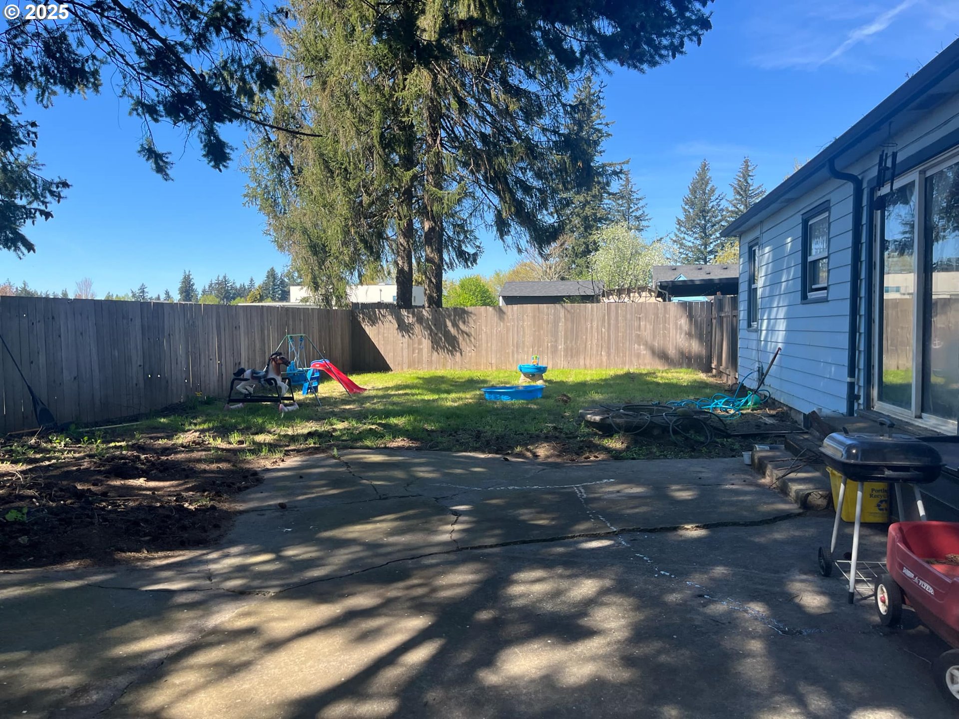 933 Southeast 174th Avenue Portland, OR 97233 - Photo 12 of 14 a view of a backyard with plants and trees