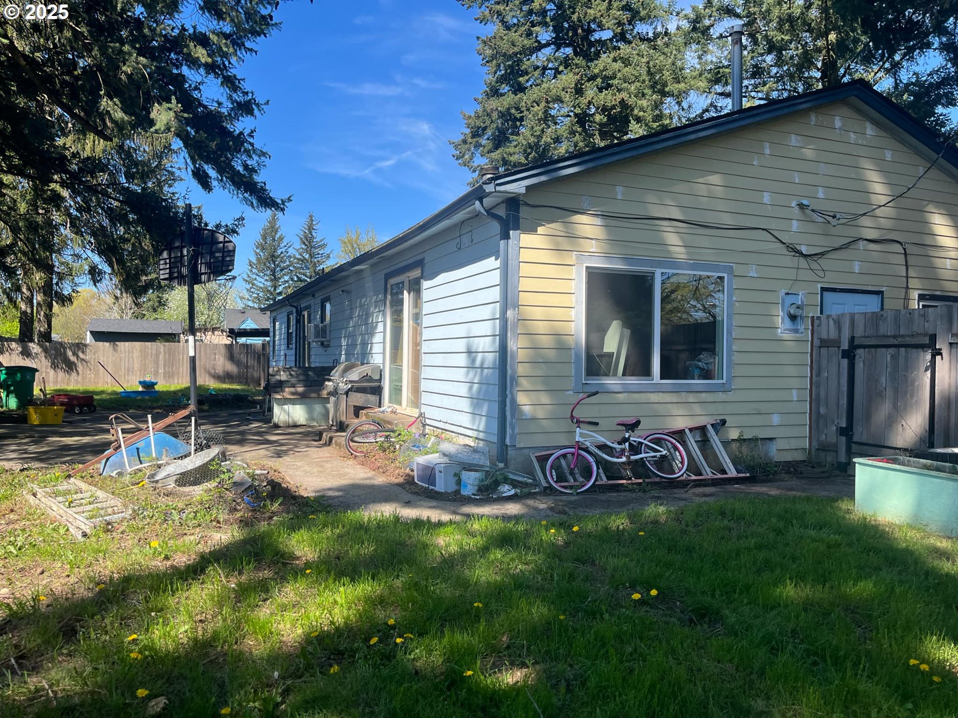 933 Southeast 174th Avenue Portland, OR 97233 - Photo 10 of 14 a view of a backyard with table and chairs potted plants and a large tree