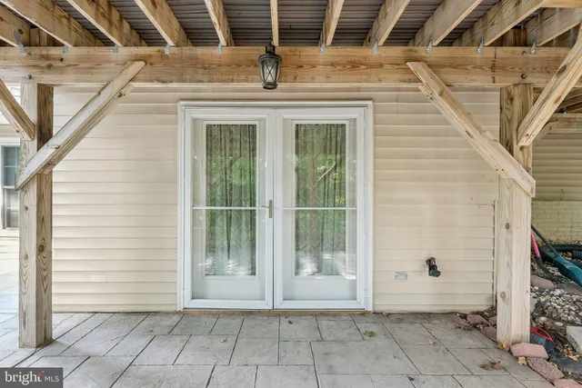 a view of a house with a door and wooden walls