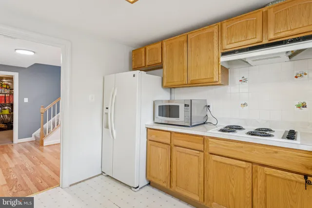 a kitchen with stainless steel appliances granite countertop a refrigerator sink and cabinets