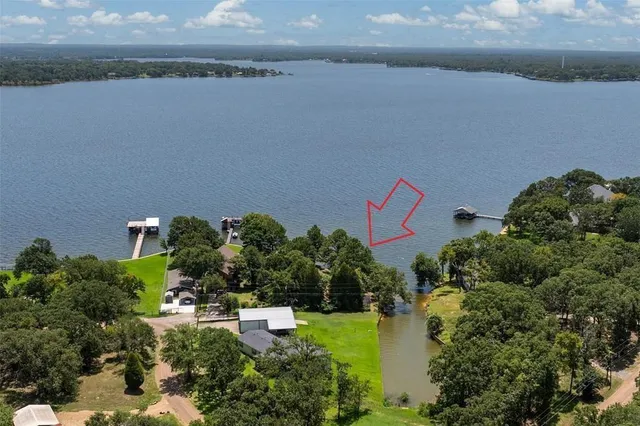 an aerial view of a house with a garden and a yard