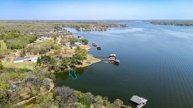 an aerial view of ocean with residential houses with outdoor space