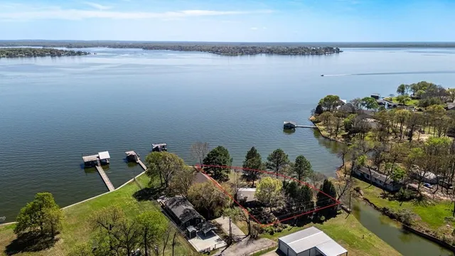 an aerial view of a house with a lake view