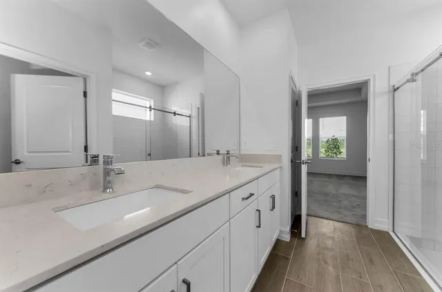a bathroom with a double vanity sink and a mirror