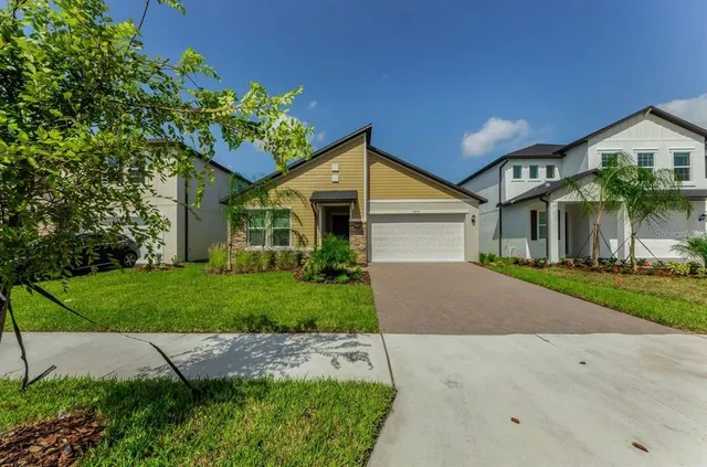 a front view of a house with a yard and garage