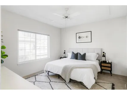 a bedroom with a bed and a wall painting