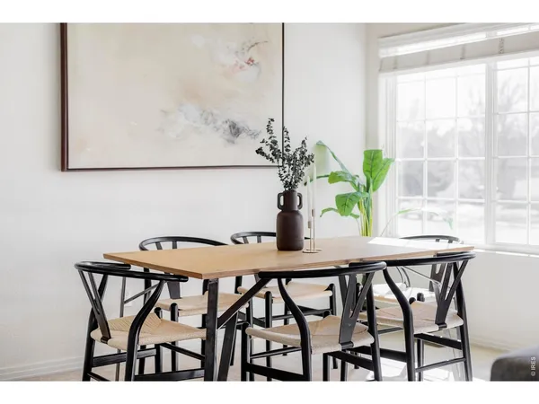 a view of a dining room with furniture and a potted plant