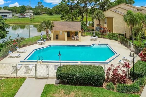 a view of house with pool garden and outdoor seating