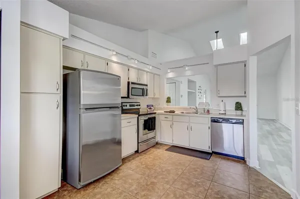 a kitchen with cabinets and stainless steel appliances