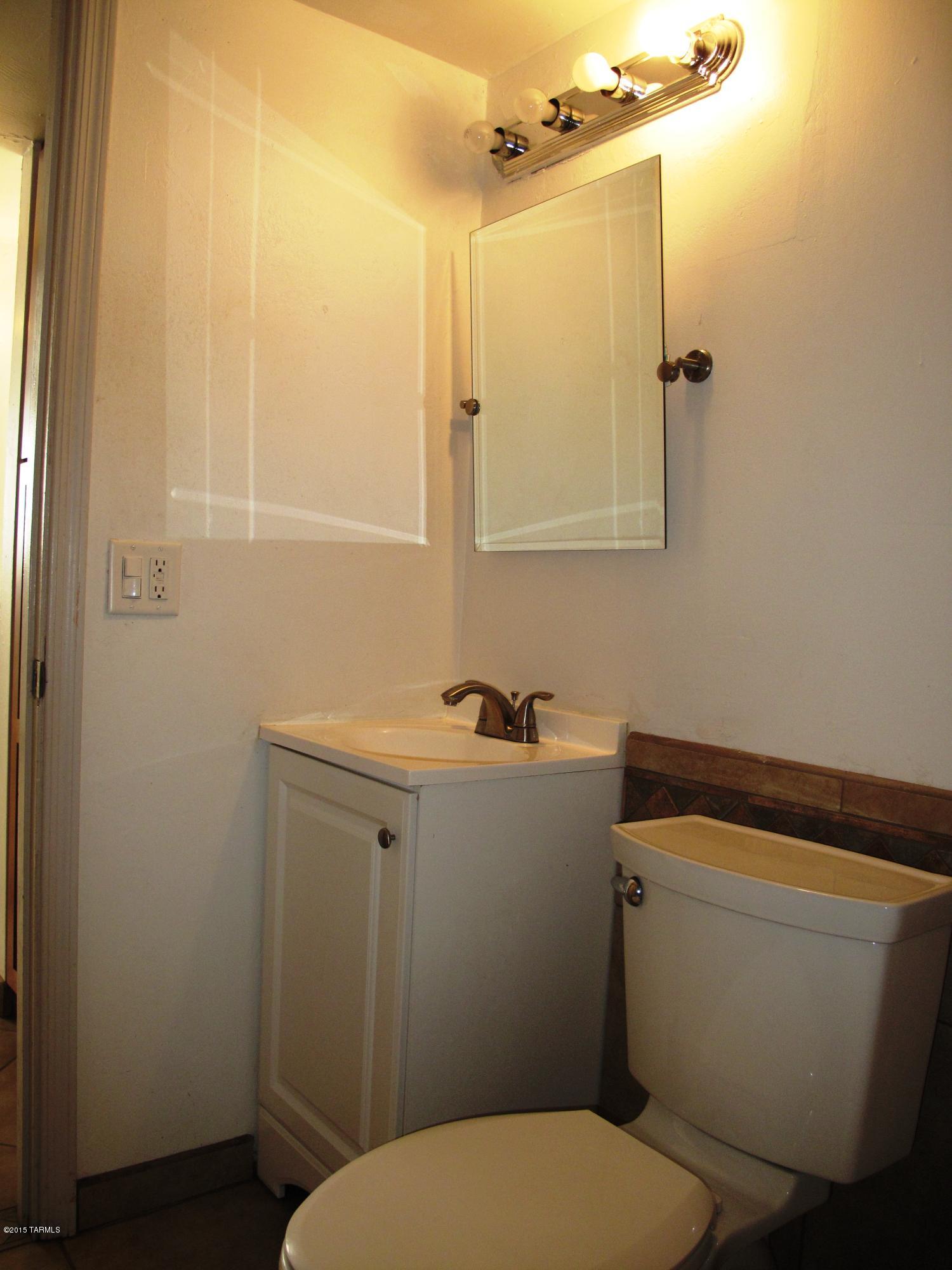 2601 South Lands End Road Tucson, AZ 85713 - Photo 9 of 15 a bathroom with a sink a toilet and shower