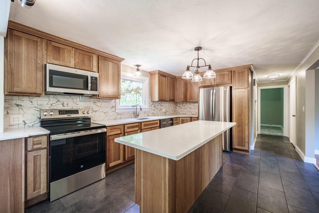 313 Bennett Road Hampden, MA 01036 - Photo 13 of 42 a kitchen with a sink stove and microwave
