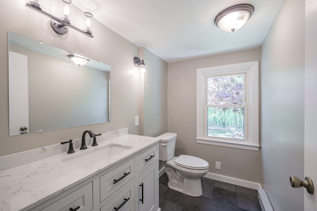 313 Bennett Road Hampden, MA 01036 - Photo 35 of 42 a bathroom with a toilet a sink and mirror