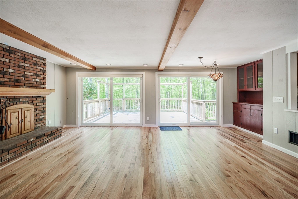 313 Bennett Road Hampden, MA 01036 - Photo 4 of 42 a view of an empty room with wooden floor and a window