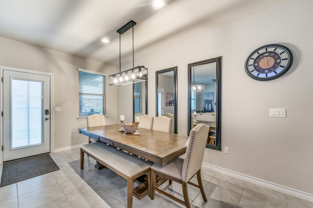 5921 Lehman Way Austin, TX 78747 - Photo 7 of 25 An inviting dining area offers ample space for gatherings and daily meals, illuminated by stylish overhead lighting.
