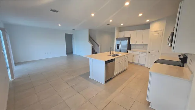 a kitchen with stainless steel appliances a microwave a sink and a refrigerator