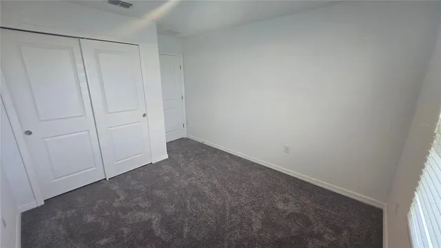 a spacious bathroom with a double vanity sink and a mirror
