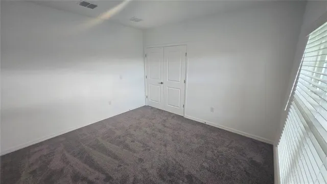 a large kitchen with stainless steel appliances a large counter top a stove and a refrigerator