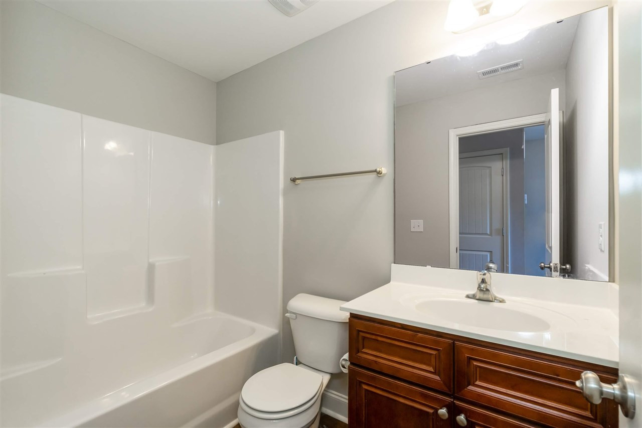 3934 Volkswalk Place Raleigh, NC 27610 - Photo 13 of 16 a bathroom with a sink a toilet and shower
