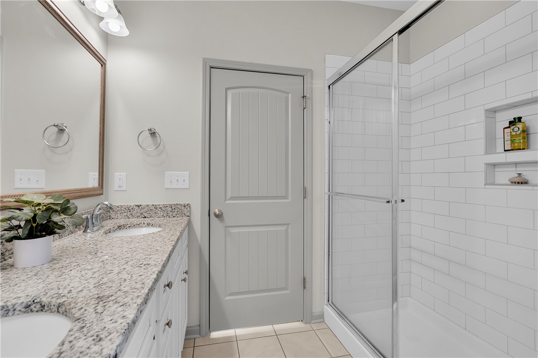 302 Phillips Drive Pendleton, SC 29670 - Photo 13 of 27 This bright bathroom features a spacious shower and a dual-sink vanity with ample counter space.