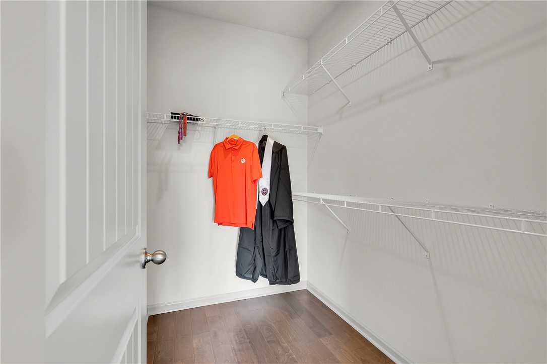 302 Phillips Drive Pendleton, SC 29670 - Photo 14 of 27 This spacious walk-in closet features ample shelving and dark hardwood flooring.