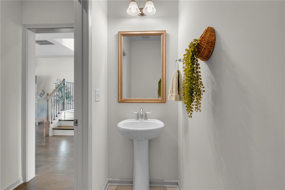 302 Phillips Drive Pendleton, SC 29670 - Photo 16 of 27 This powder room features a classic pedestal sink, offering functional elegance and a bright, inviting atmosphere.