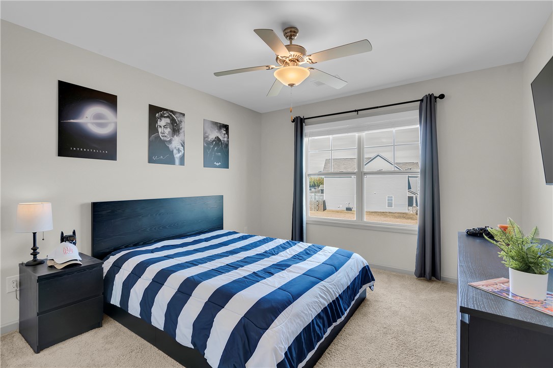302 Phillips Drive Pendleton, SC 29670 - Photo 20 of 27 This cozy bedroom features plush carpeting and abundant natural light through a large window.