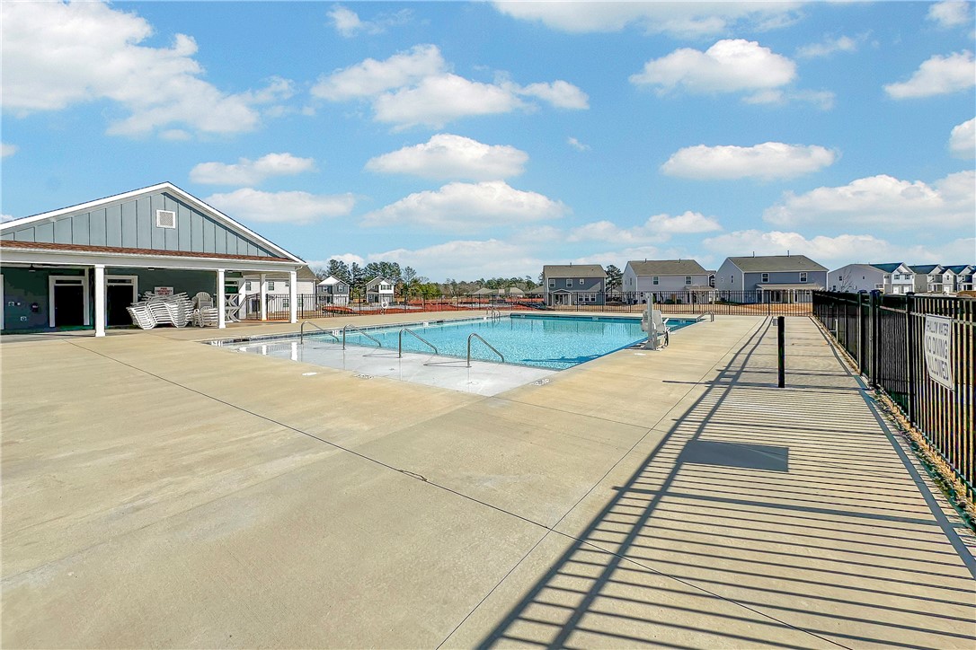 302 Phillips Drive Pendleton, SC 29670 - Photo 26 of 27 This community pool and clubhouse offers an inviting recreational space under clear skies.