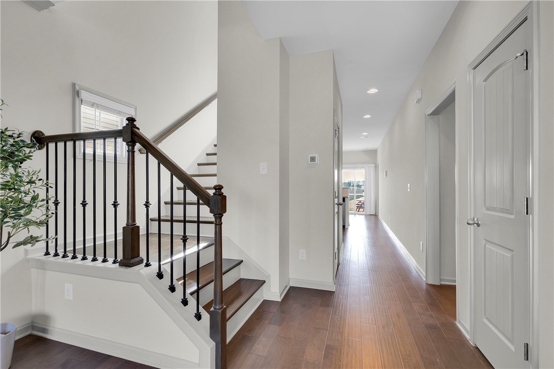 302 Phillips Drive Pendleton, SC 29670 - Photo 4 of 27 This inviting hallway features rich hardwood flooring, leading to a sunlit space and an elegant staircase.