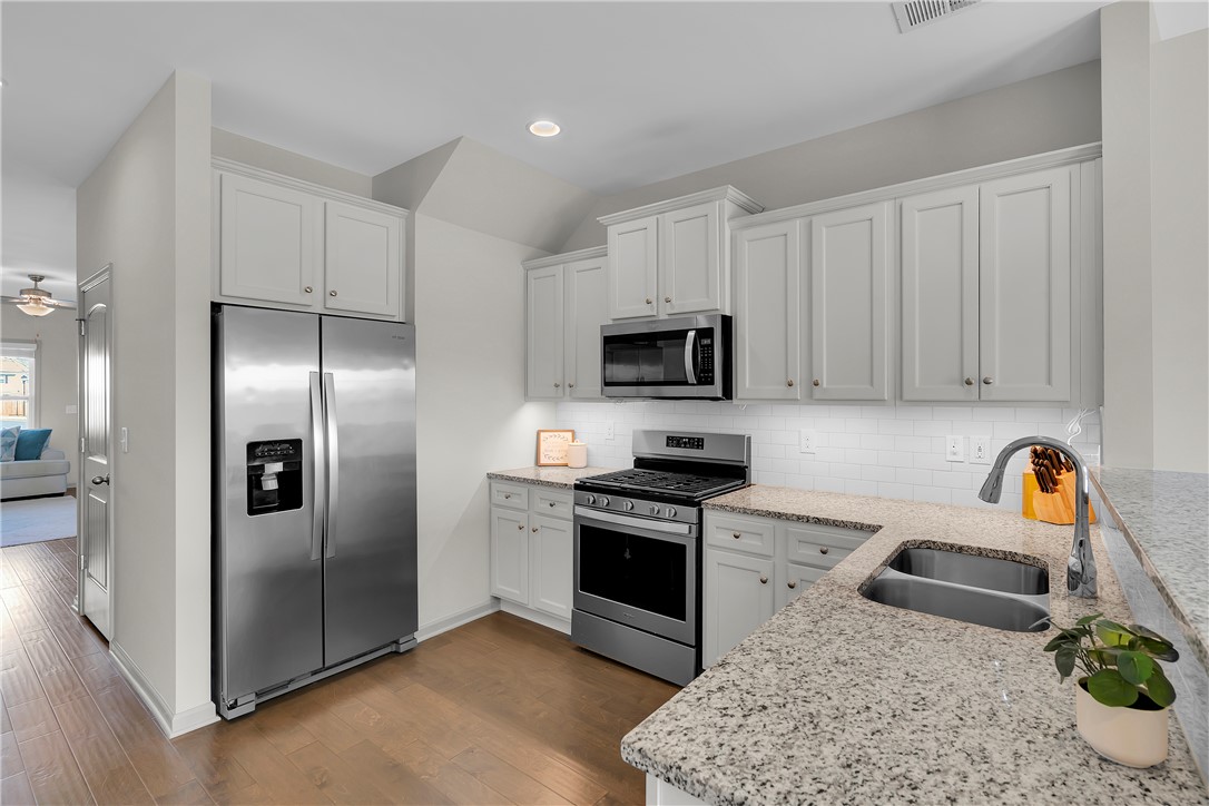 302 Phillips Drive Pendleton, SC 29670 - Photo 7 of 27 This modern kitchen features stainless steel appliances and abundant cabinetry, perfect for culinary endeavors.