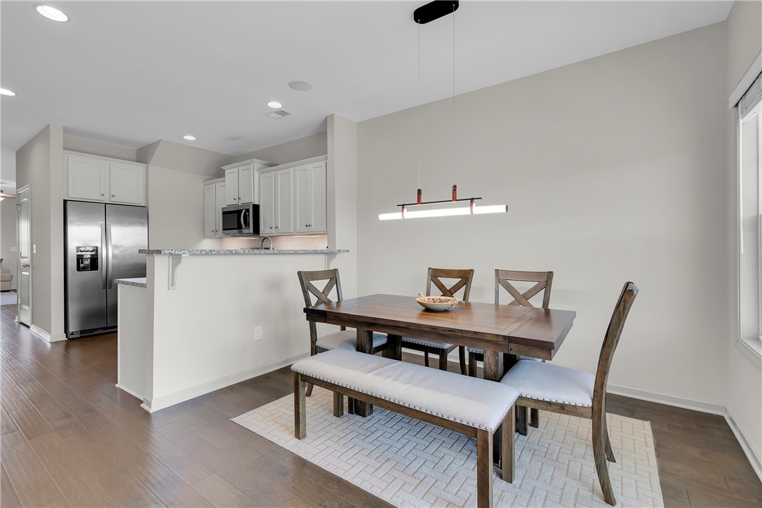 302 Phillips Drive Pendleton, SC 29670 - Photo 8 of 27 This inviting dining area features elegant hardwood flooring and ample natural light.