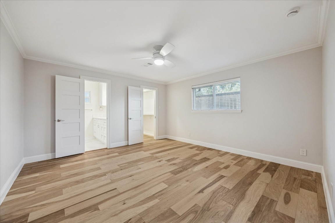 10422 Raritan Drive Houston, TX 77043 - Photo 14 of 31 a view of an empty room with wooden floor and a window