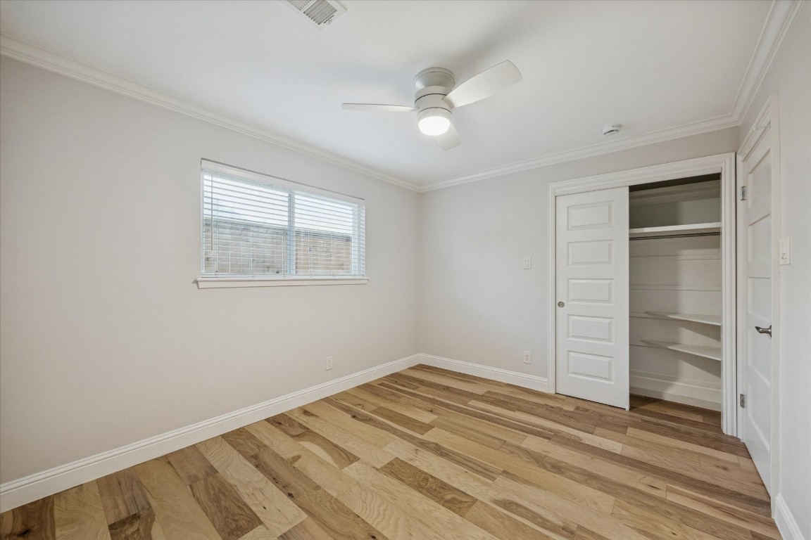 10422 Raritan Drive Houston, TX 77043 - Photo 18 of 31 a view of a room with wooden floor and closet