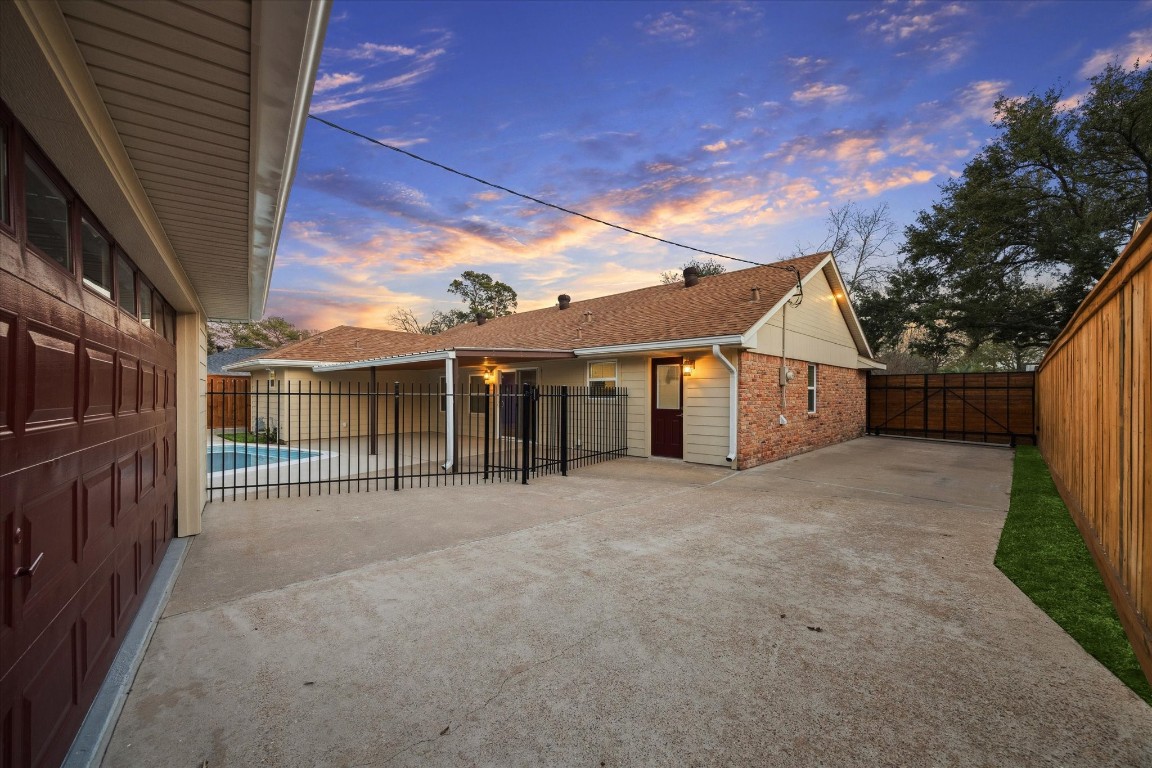 10422 Raritan Drive Houston, TX 77043 - Photo 22 of 31 a view of a house with a backyard