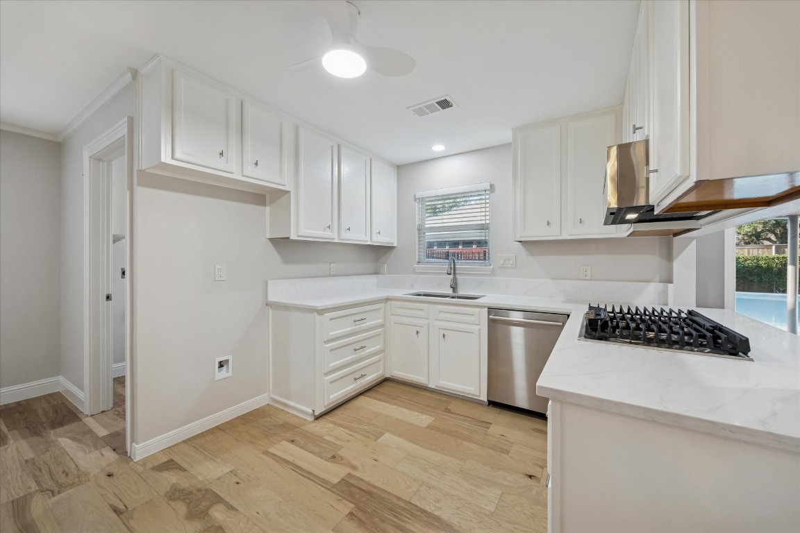 10422 Raritan Drive Houston, TX 77043 - Photo 9 of 31 a kitchen with granite countertop a sink a stove and cabinets