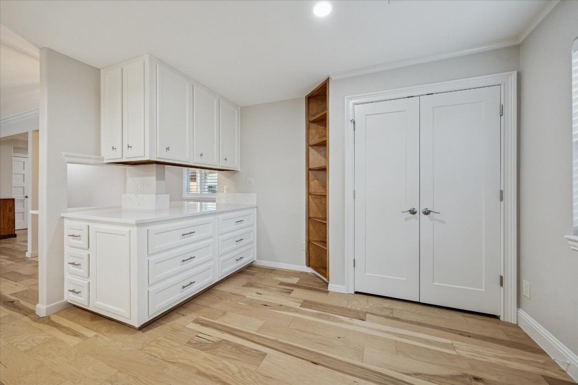 10422 Raritan Drive Houston, TX 77043 - Photo 10 of 31 a room with white cabinets and a wooden floor