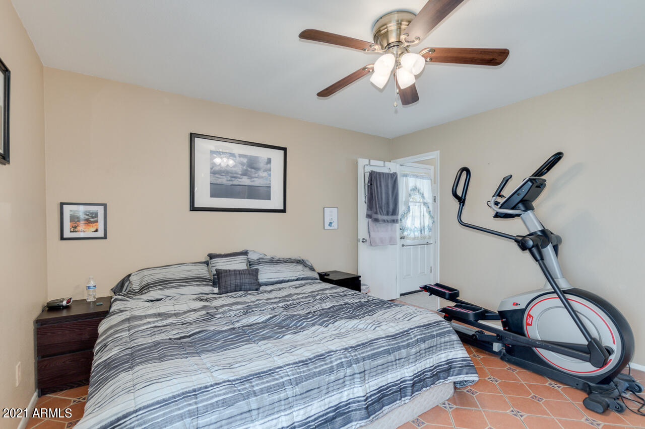 4215 West Dailey Street Phoenix, AZ 85053 - Photo 16 of 32 a bedroom with a bed and a chandelier