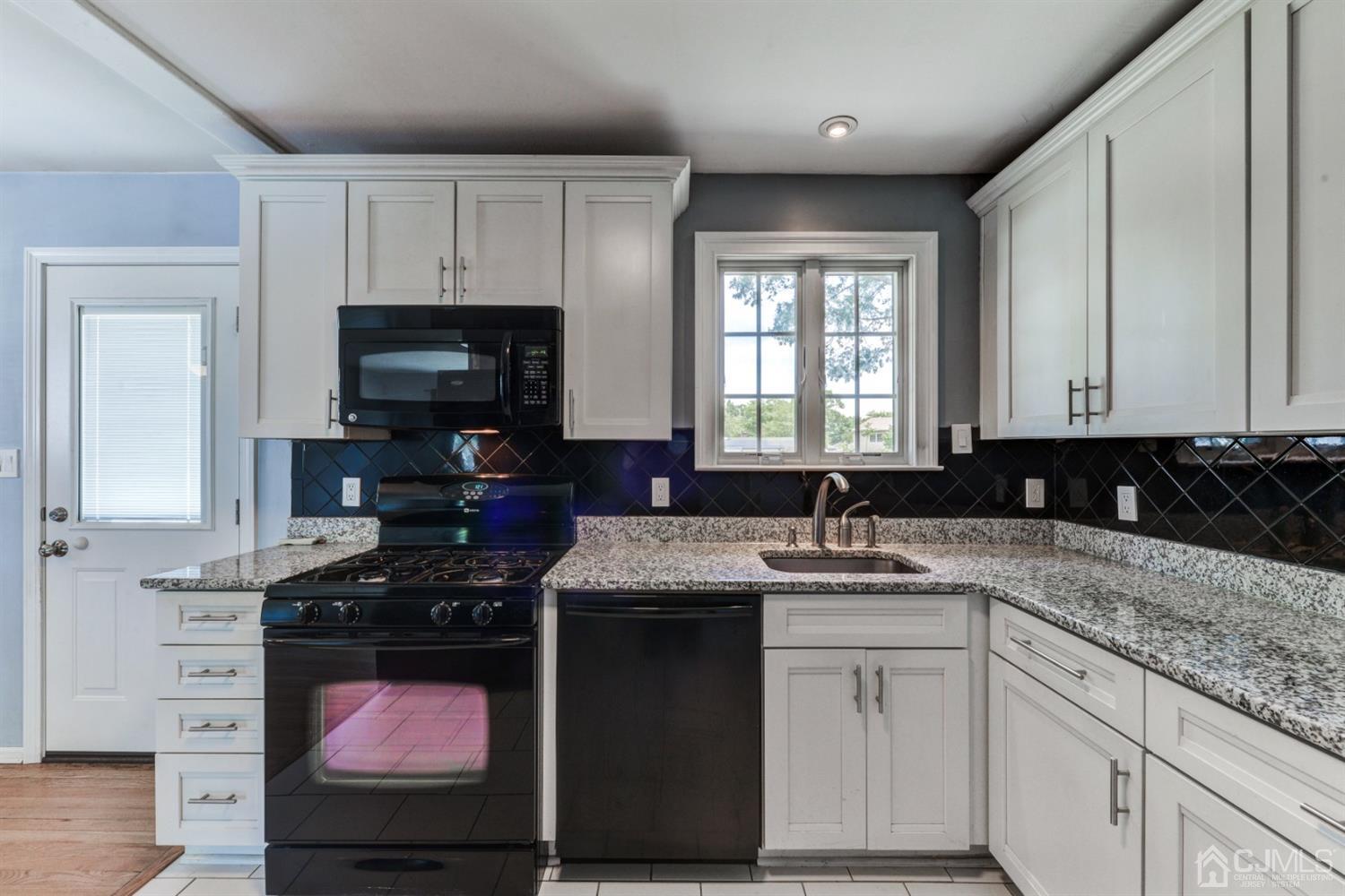 37 Finley Road Edison, NJ 08817 - Photo 11 of 29 a kitchen with stainless steel appliances granite countertop a stove a sink and a microwave