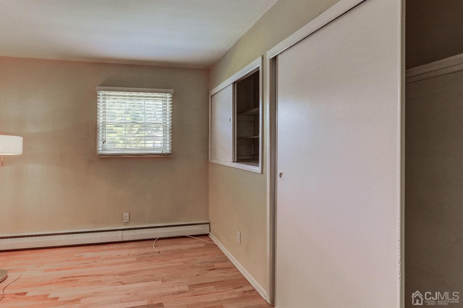 37 Finley Road Edison, NJ 08817 - Photo 17 of 29 a view of an empty room with wooden floor and a window
