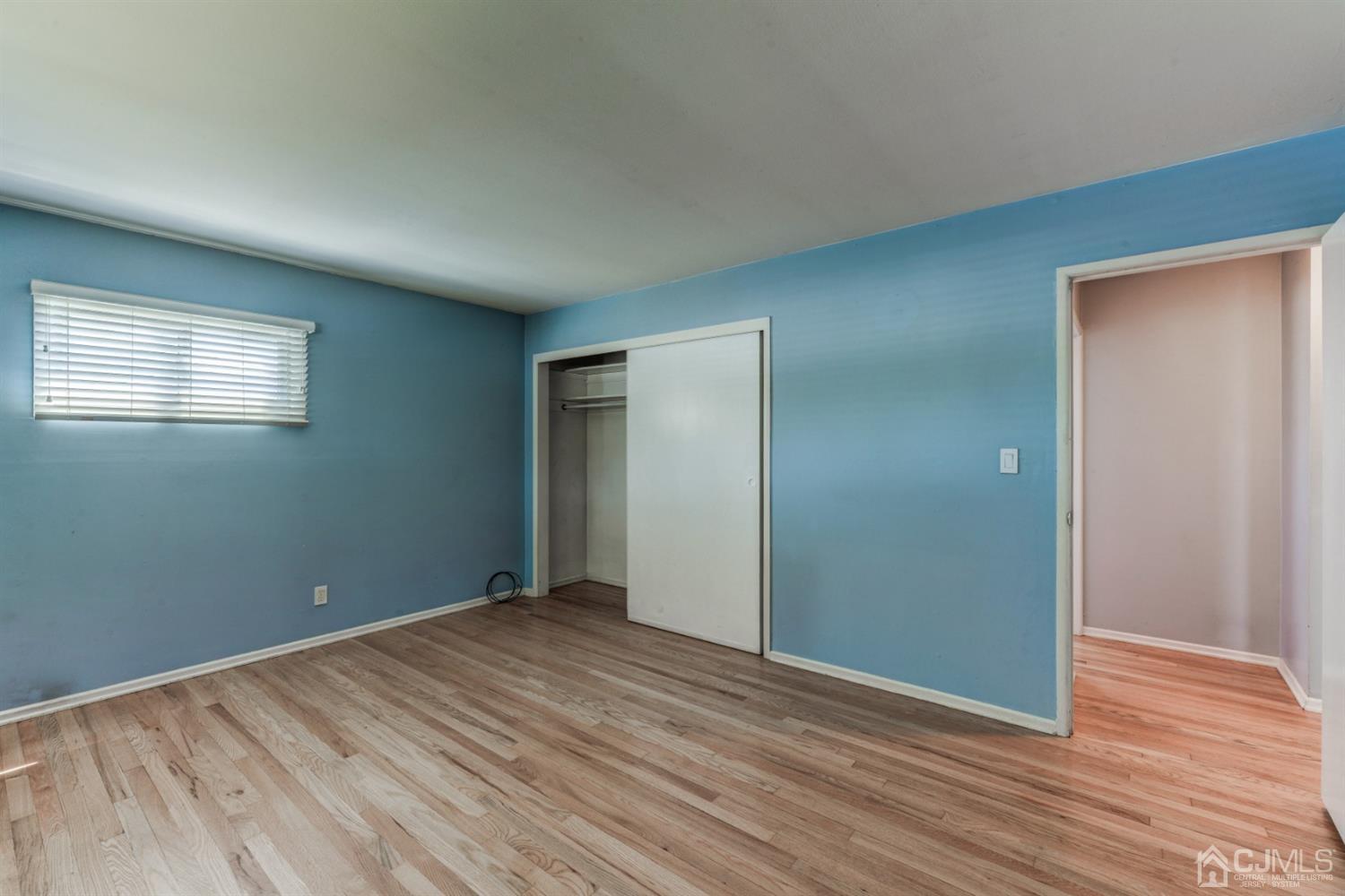 37 Finley Road Edison, NJ 08817 - Photo 20 of 29 a view of an empty room with wooden floor and a window