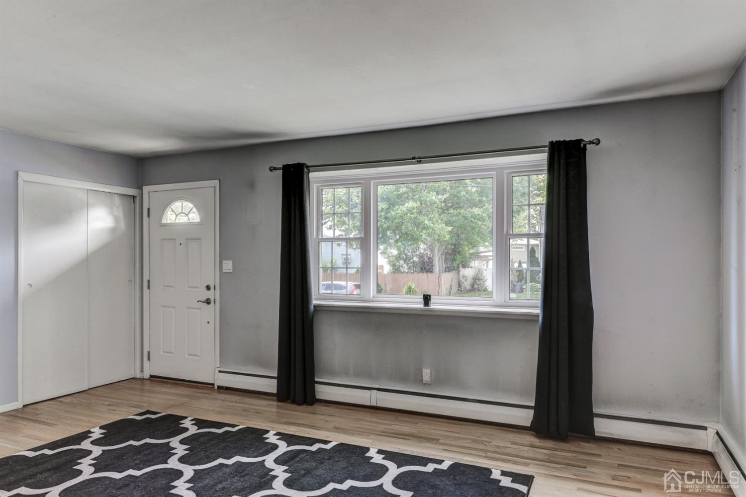 37 Finley Road Edison, NJ 08817 - Photo 5 of 29 a view of an empty room with wooden floor and a window